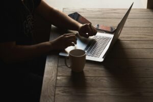 Read more about the article gray laptop computer on brown wooden table beside person sitting on chair