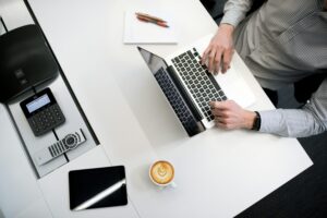 Read more about the article person using laptop on white wooden table